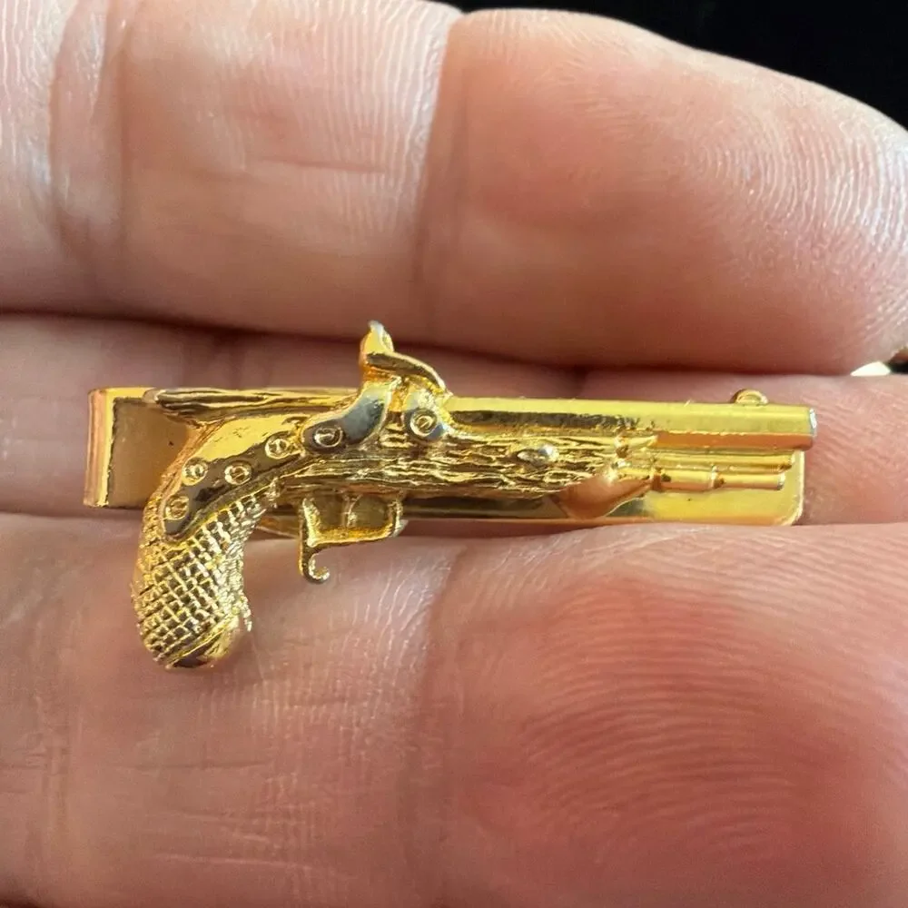 Gold tone revolver gun tie clip and cuff links